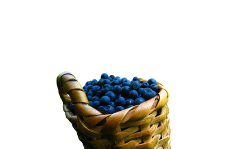 Isolated blueberry. One wicker basket of blueberries isolated on white backgroundの写真素材