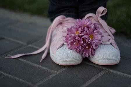 Pink gym shoes and pink bouquetの写真素材