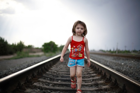 The little girl goes on railsの写真素材
