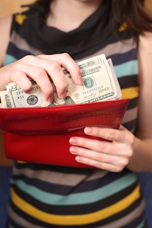 Female hands get money from a purseの写真素材