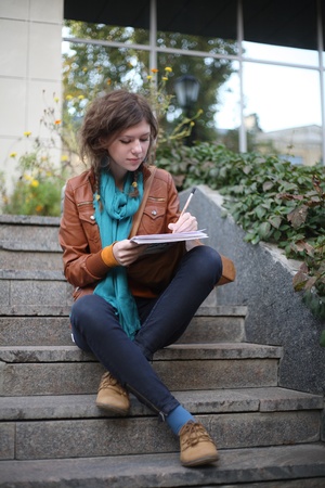 The artist sits at steps and drawsの写真素材