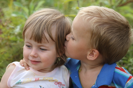 little boy kissing his little sisterの写真素材