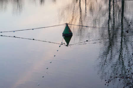 Divided water surface. Floating center intersection. Cables floats and determine sectorReflection surface creates the impression of spaciousness.の写真素材