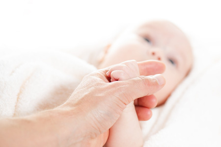 Concept of love and family. hands of father and baby closeupの写真素材