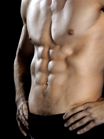 Muscular male torso on blackの写真素材