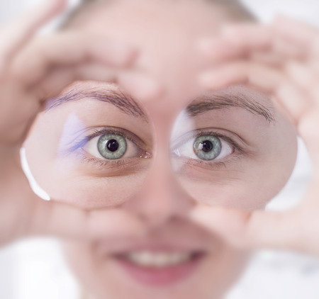 Woman looking through lensesの写真素材