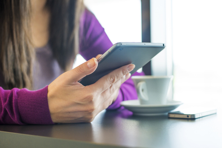 Close up shot woman using tablet in officeの写真素材