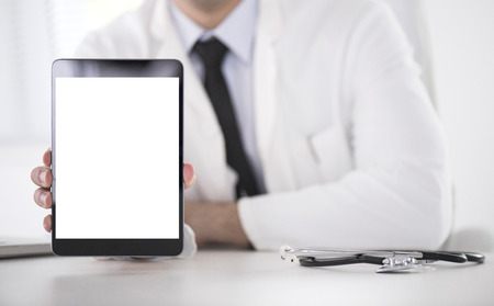 Cropped shot of a male doctor using a digital tablet.の写真素材