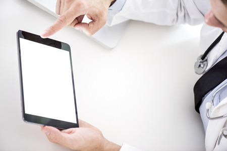 Cropped image of a doctor working on his digital tablet.He is showing digital tablet with blank screen.の写真素材