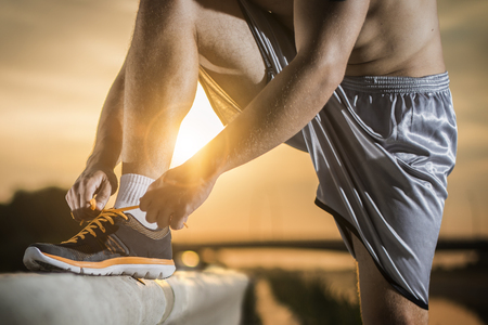 Man tying jogging shoes.の写真素材