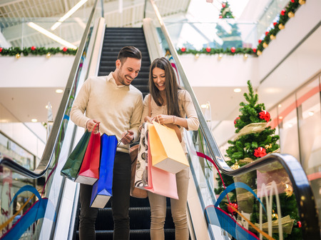 happy young couple with shopping bags.の写真素材