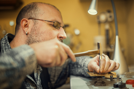 Watchmaker at work.Old pocket watch being repaired by watch maker.の写真素材