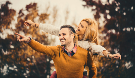 Couple in the autumn park.Smilling man and woman outside.の写真素材