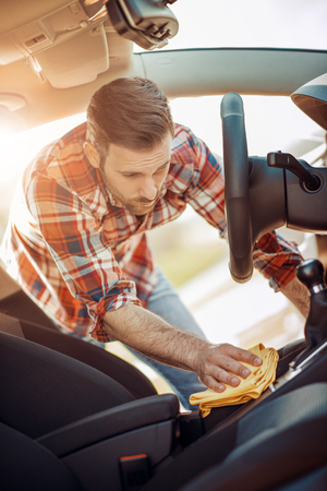 Man cleaning the interior of his carの写真素材
