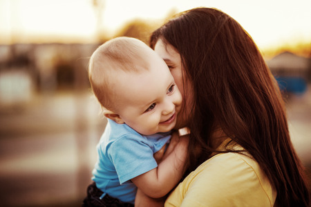 Mother with son.Young woman with a cute baby boy on her hands.の写真素材