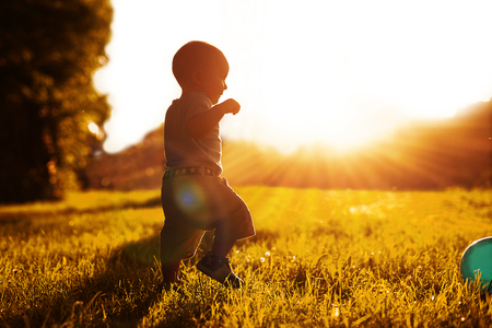 Baby's first independent steps on the grass.の写真素材