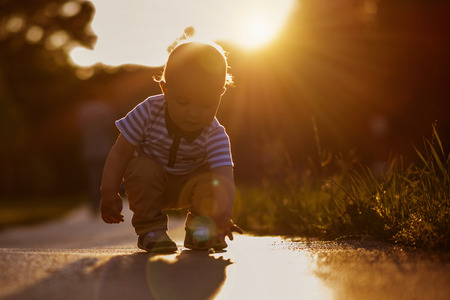 Baby boy playing in the park at the summer day.の写真素材