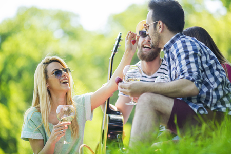 Best friends enjoying picnic together.Happy friendship concept and fun with young people.の写真素材