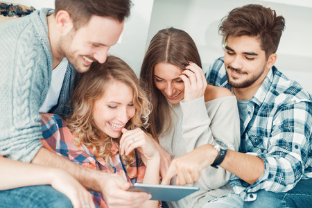 Cheerful group of friends having fun at home,taking selfie.の写真素材