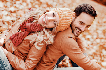 Couple in love in autumn.Smiling young couple hugging in the park.の写真素材
