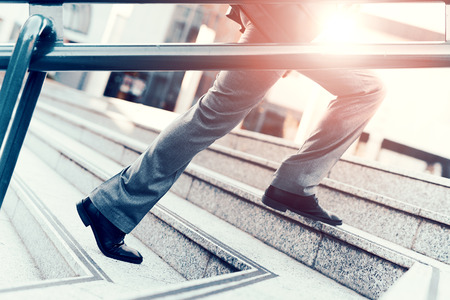 Cropped view of businessman holding a briefcase outdoors