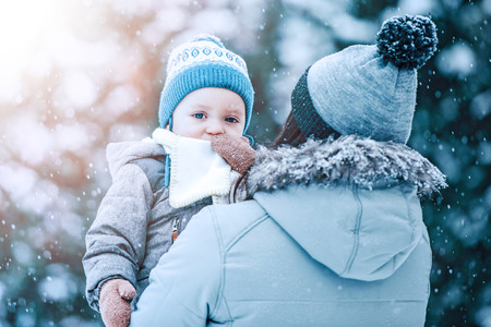 Mother and son enjoying beautiful winter day outdoors.