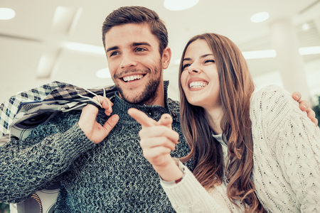 Portrait of happy couple with shopping bags.の写真素材