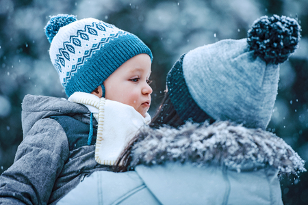 Mother and son enjoying beautiful winter day outdoors.の写真素材