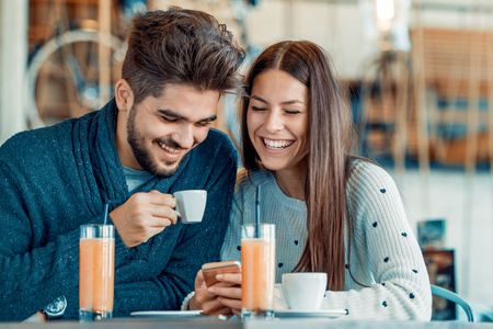 Happy couple enjoying a coffee at the coffee shop.の写真素材
