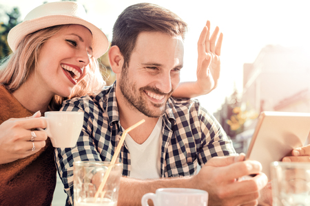 Happy couple enjoying a coffee at the coffee shop.の写真素材