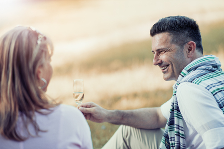 Shot of a beautiful mature couple on a picnic and making a toast.の写真素材