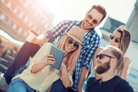 Group of friends taking a selfie with smartphone.の写真素材
