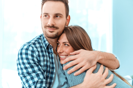 Young couple in love hug each other at home.の写真素材