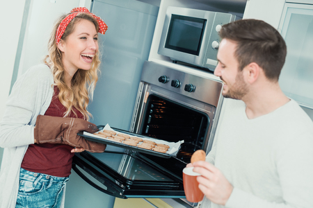 Happy couple making cookies at home.Couple,food,hapiness and people concept.の写真素材