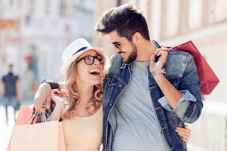 Happy couple of turists shopping in the city.の写真素材