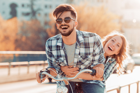 Couple riding their bikes in their free time and having fun on a sunny summer day.の写真素材