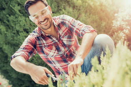 Young gardener with a professional garden tools at work.の写真素材