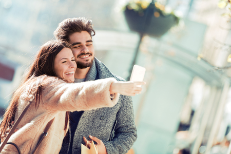 Happy young couple hugging and laughing outdoors,having fun.の写真素材