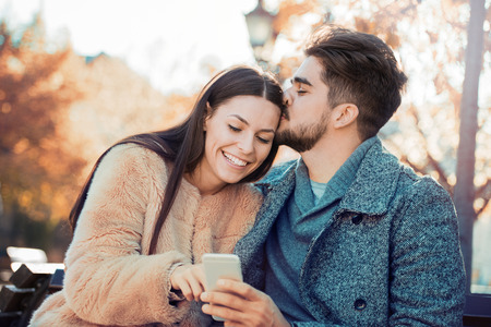 Happy young couple hugging and laughing outdoors,having fun.の写真素材
