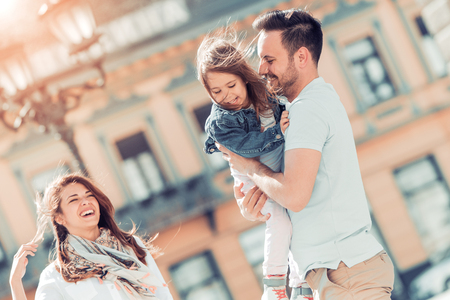 Happy family having fun outdoors and smiling.の写真素材