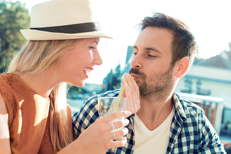Happy young couple having fun outdoors and smiling.