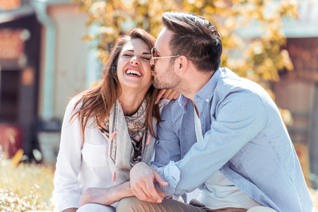 Smiling couple in love outdoors.Young happy couple hugging on the city street, having fun together.の写真素材