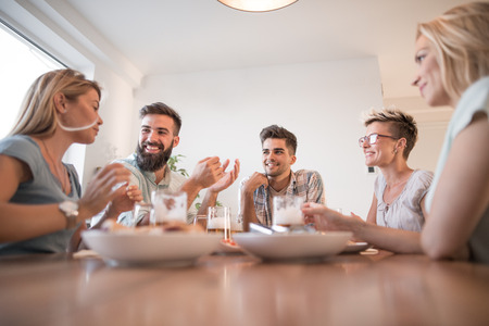 Young people having lunch together at home,having fun together.の写真素材