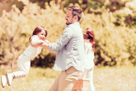 Happy young family having fun in the park.の写真素材