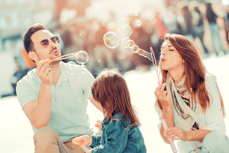 Beautiful young family having fun outdoors.の写真素材