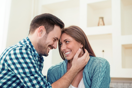 Portrait of happy couple relaxing at home.Relationship, love. Lovely couple togetherの写真素材