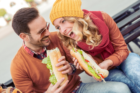 Happy loving couple enjoying breakfast in the city,having fun.の写真素材