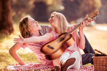Young couple in love doing a picnic outdoors.の写真素材