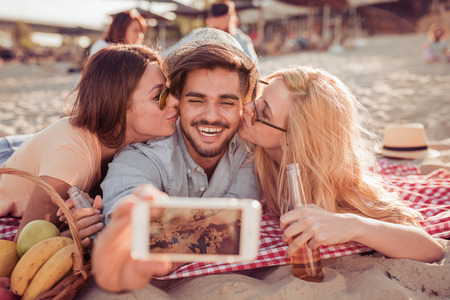 Group of friends taking selfie with smart phone.の写真素材
