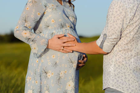 Portrait of a pregnant woman with her boyfriend. Happy couple expecting a baby, young family concept